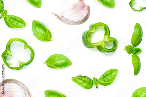Creative food pattern with Fresh vegetables, herbs and spices isolated on white background.  Flat lay. Healthy food background basil leaves, garlic, green pepper. Close up.
