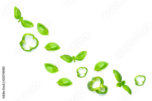 Isolated Flying herbs.Creative layout with basil leaf, paprika, green pepper. Flat lay. Food ingredients isolated on white background, close up.