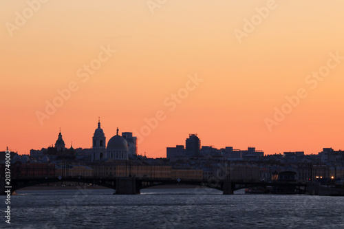 View on the Exchange Bridge in the rays of sunset between Petrogradsky Island and Vasilievsky Island in St. Petersburg, Russia.