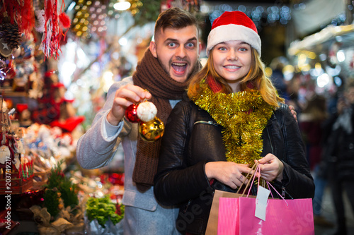 Couple in Christmas hat happinnes from buying decoration
