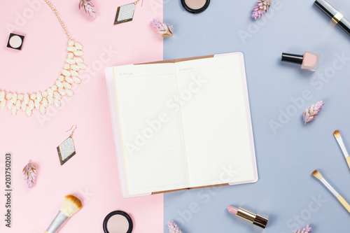 Blank note book, woman beauty accessories flat lay on pastel background. Fashion or beauty blogger concept.