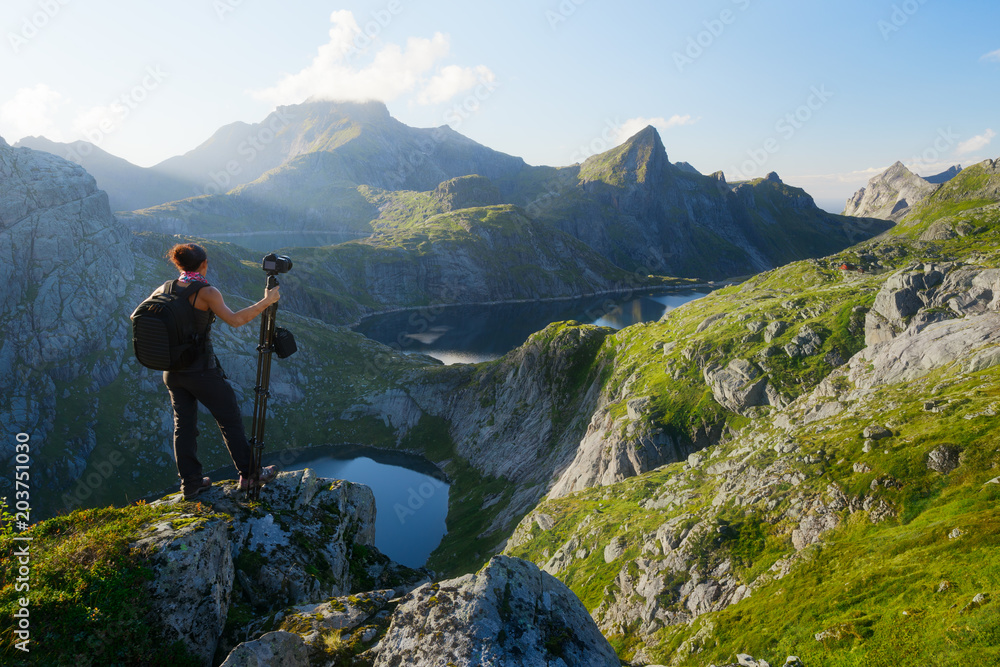 Woman photographer looking at Munkebu mountains in Lofoten