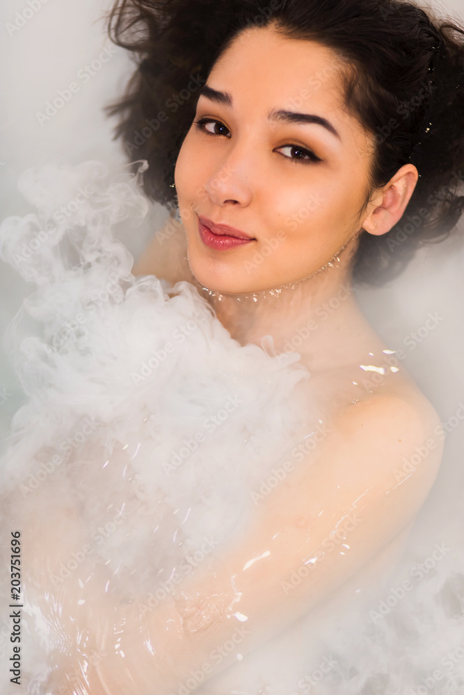 Close-up portrait of a young beautiful brunette woman takes bath Close-up portrait of a young beautiful brunette woman takes bath