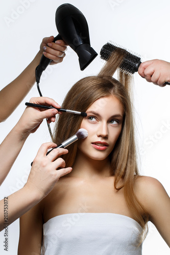 beautiful girl getting hair and makeup