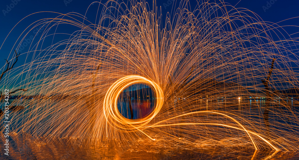 Fire spin with long explosure on the water. Fire spin with long explosure on the water.
