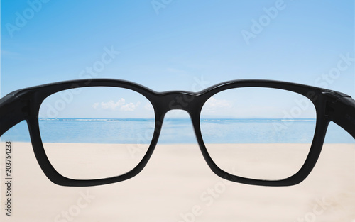 Summer holiday and vacation. Looking through sunglasses lens to beautiful beach in summer