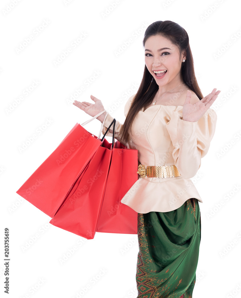woman in Thai traditional dress holding a shopping bag isolated on white background woman in Thai traditional dress holding a shopping bag isolated on white background