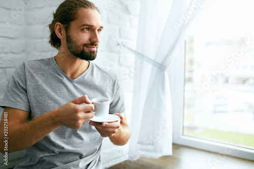 Man Drinking Coffee At Home In Morning.