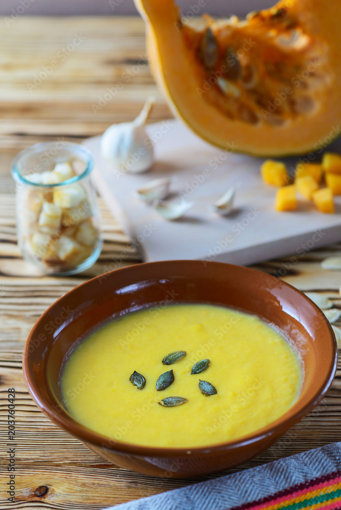 Pumpkin soup on a wooden table Pumpkin soup on a wooden table