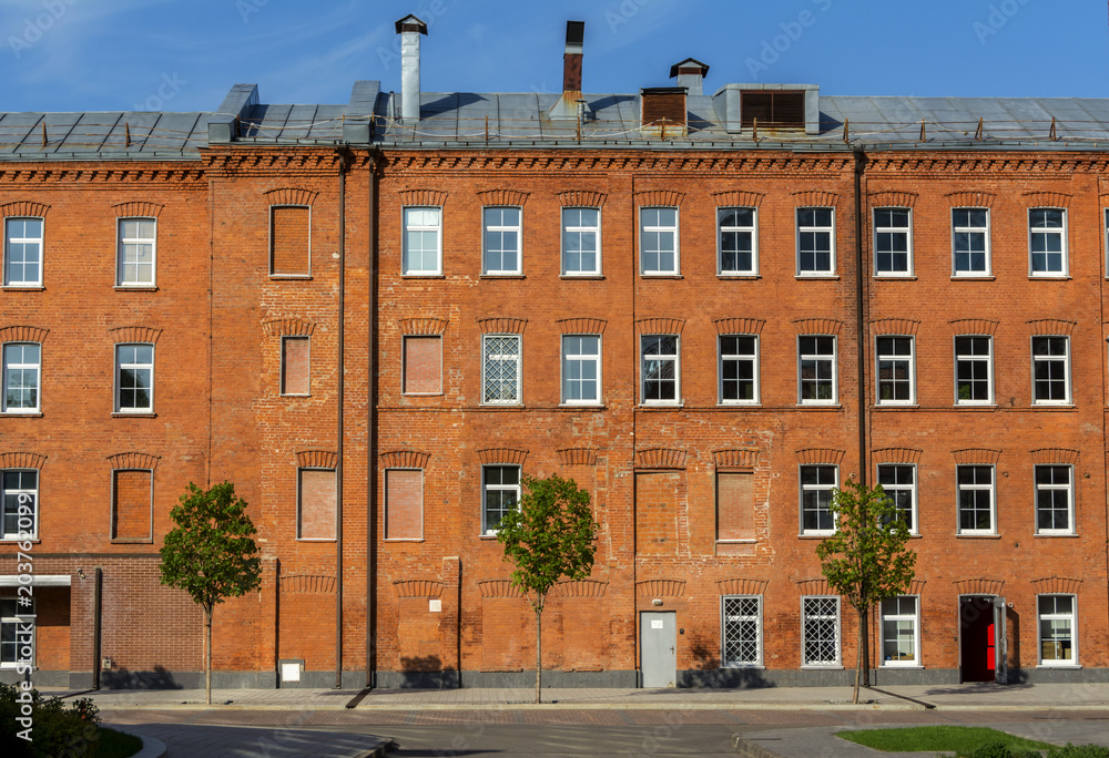 Office building of red brick in the yard of the old factory
