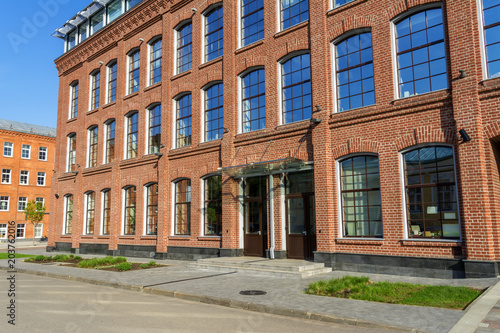 Office building of red brick in the yard of the old factory