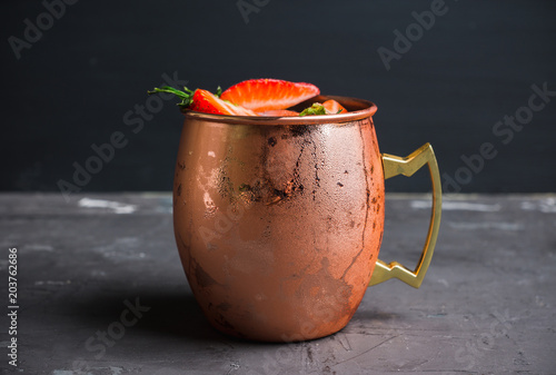 Photography Strawberry moscow mule on thr rustic background. Selective focus.