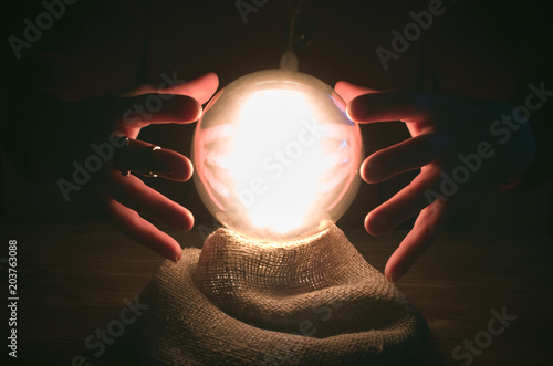 Crystal ball and fortune teller hands. Divination concept. The spiritual seance. Future reading.
