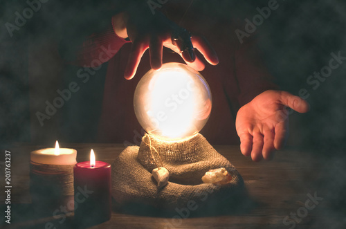 Crystal ball and fortune teller hands. Divination concept. The spiritual seance. Future reading.