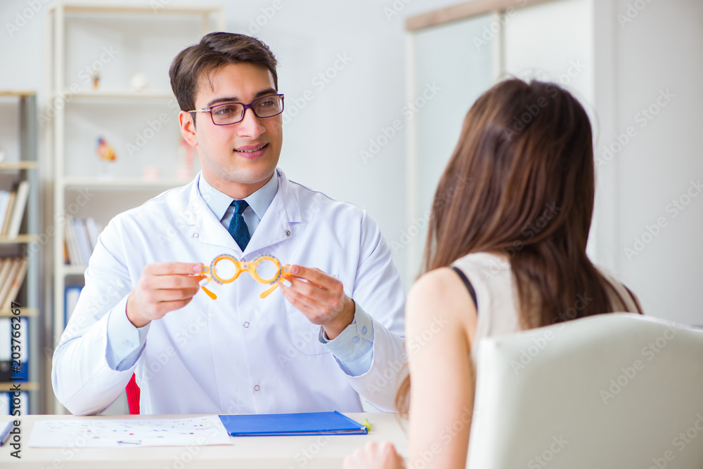 Ophthalmologist is checking up patient in eye doctor hospital