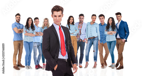 relaxed businessman standing in front of his young casual team