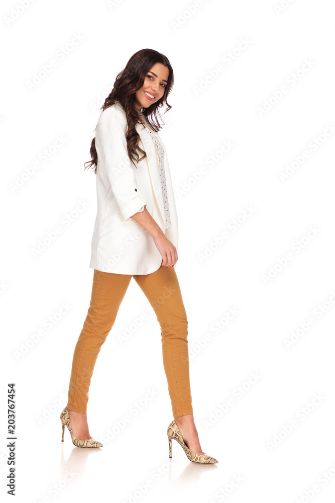 side view of happy brunette businesswoman with high heels