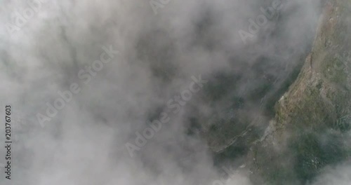 Clouds moving in sky about Kelimutu volcano crater aerial view, Indonesia photo