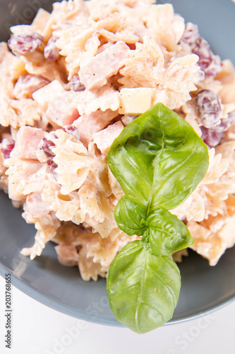 Pasta salad with cheese, ham, kidney beans and mayonnaise