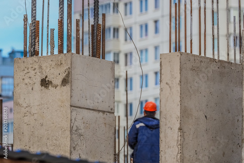 Building construction site with tower crane against blue sky