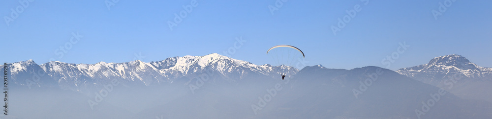 Banner: Paragliding against mountain tops