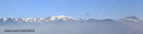 Banner: Paragliding against mountain tops