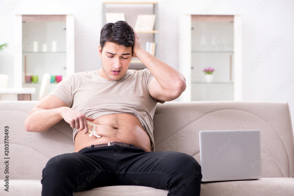 Man measuring body fat with calipers Man measuring body fat with calipers