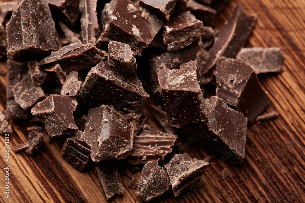 crumbs of black chocolate on a wooden background crumbs of black chocolate on a wooden background