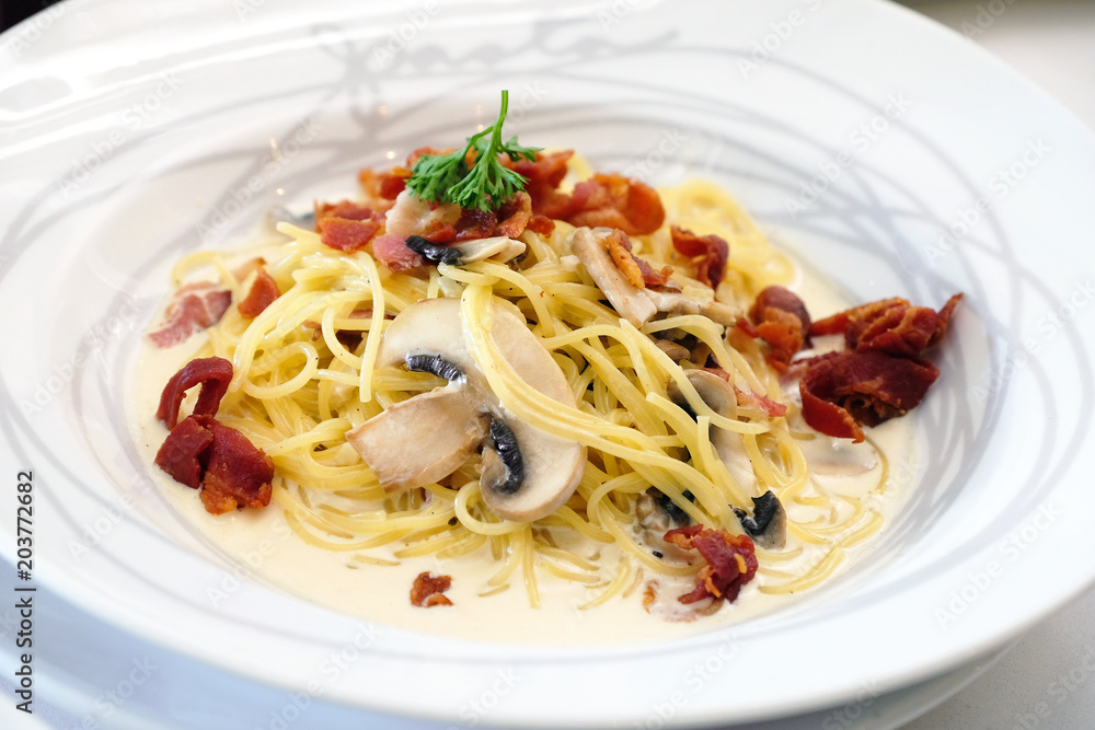 Spaghetti carbonara with grill bacon on white dish Spaghetti carbonara with grill bacon on white dish
