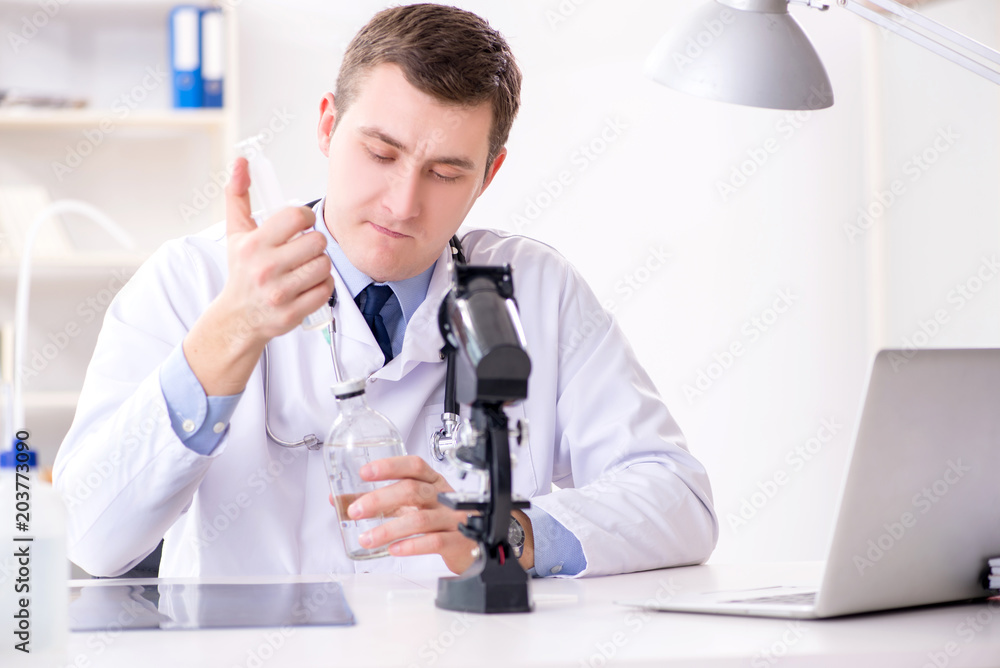 Male doctor looking at lab results in hospital Male doctor looking at lab results in hospital