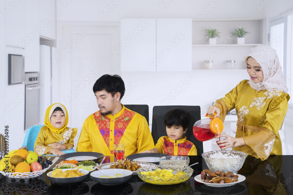 Beautiful woman pouring syrup for her family Beautiful woman pouring syrup for her family