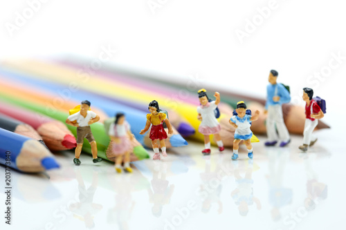 Miniature people : children and student with colorful drawing tools and stationary,education concept.