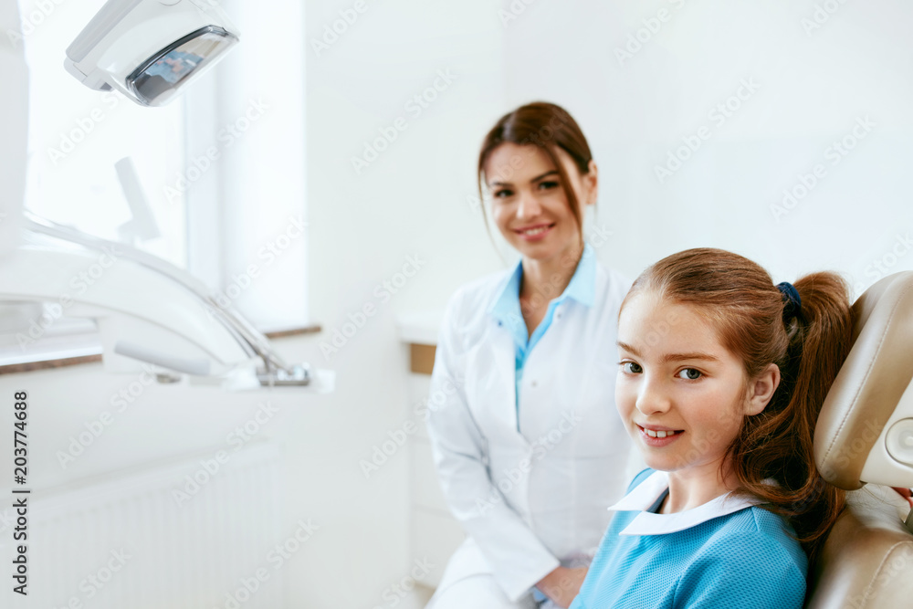 Dental Health. Dentist And Happy Girl In Dentistry Office Dental Health. Dentist And Happy Girl In Dentistry Office