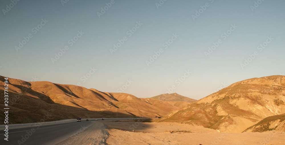 Fototapeta premium Majestic landscape of mountains and Meadow. Cycling mountain road. Misty mountain road in high mountains.. Cloudy sky with mountain road.