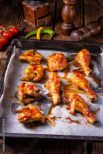 Rustic backed chicken wings,legs on baking tray