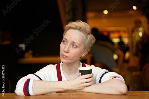 girl drinking coffee in a cafe