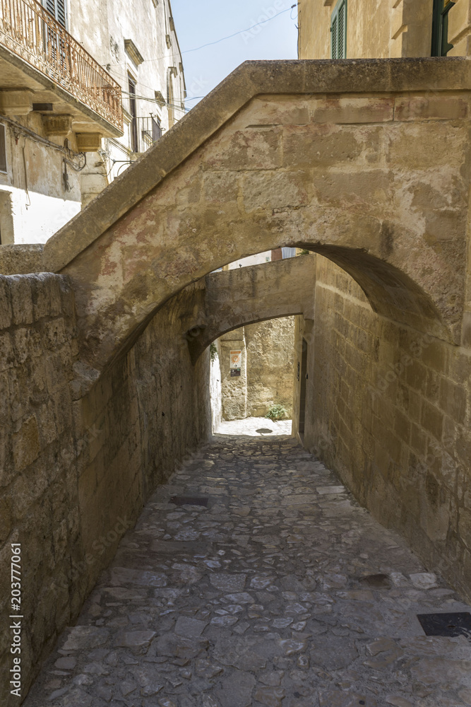 Ancient  street in Matera, with arched bridges
