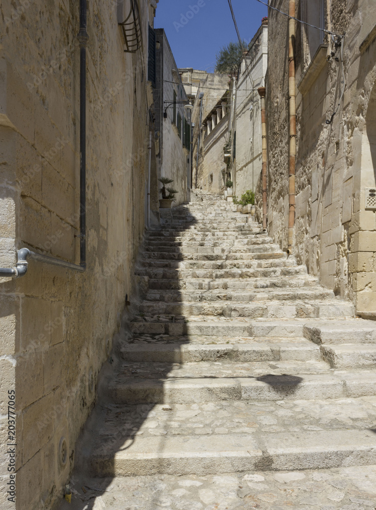 Historic ancient stone staircase in a narrow alley in the historic sassi district of Matera
