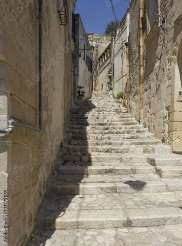 Historic ancient stone staircase in a narrow alley in the historic sassi district of Matera