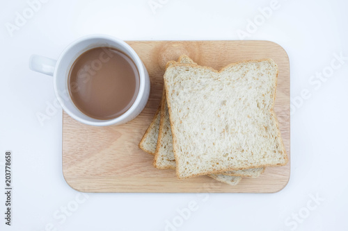 Sliced Whole wheat bread and a cup of coffee on Chopping Wood on white background, Healthy concept.