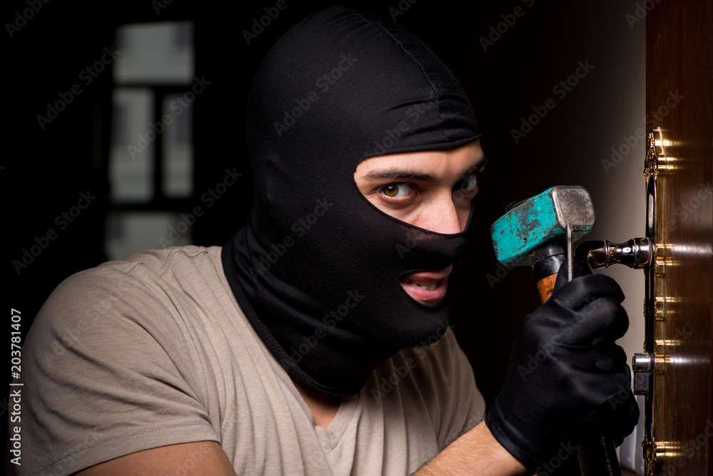 Burglar wearing balaclava mask at crime scene Burglar wearing balaclava mask at crime scene