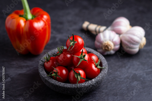 bowl of cherry tomatos on dark surface