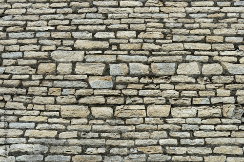 Rough grey stone brick wall