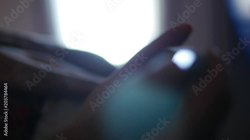 Woman hand using smartphone during plane flight