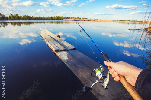 Fishing with rod on lake