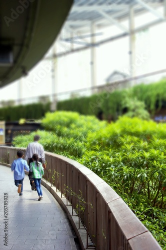 Children and adults on the corridor inside the building are decorated with greenery. © chaiyoot