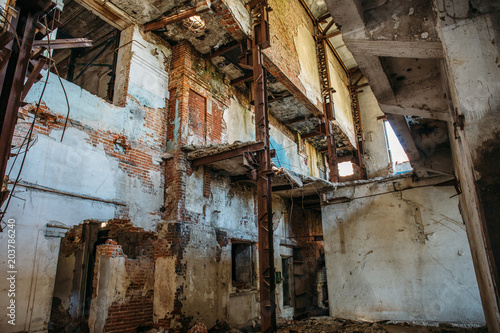 Ruins of industrial building interior after disaster or war or earthquake. Workshop with collapsed floors, devastation and consequences of disasters © DedMityay