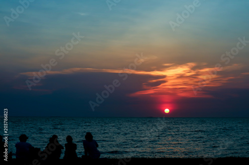 silhouette people look sunset sky on beach