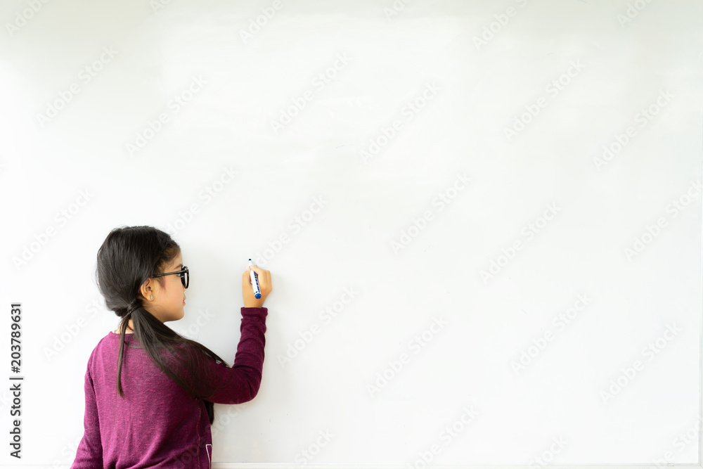 Beautiful girl writing on a blank whiteboard,education and school concept. Beautiful girl writing on a blank whiteboard,education and school concept.