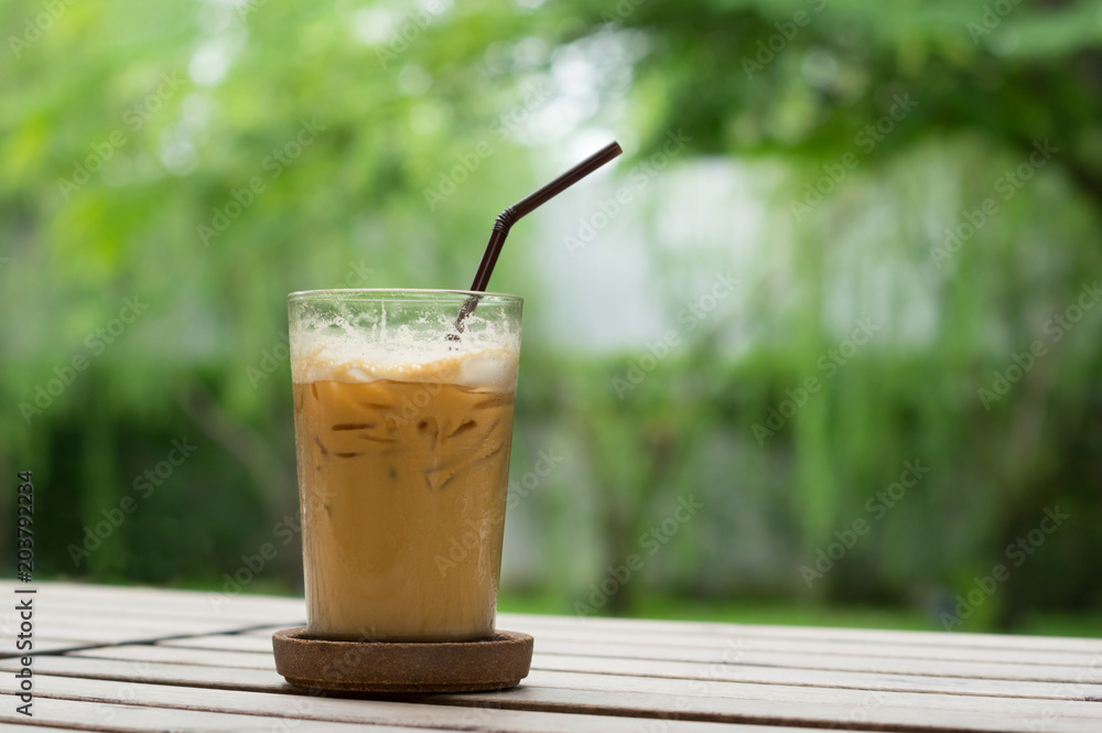 Iced coffee glass on wood table. Iced coffee glass on wood table.